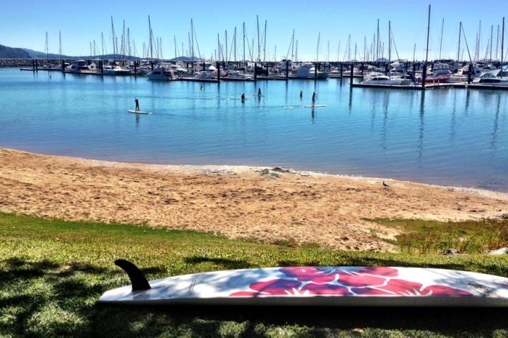 A SUP on a beach with the marina in the background