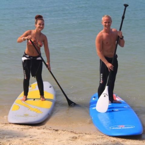 A couple on SUPs for their honeymoon in the Whitsundays