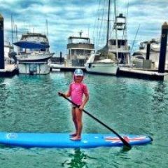 a small girl on a SUP in the Whitsundays