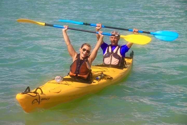 a person riding on the back of a boat in the water