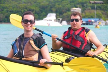 a group of people rowing a boat in the water